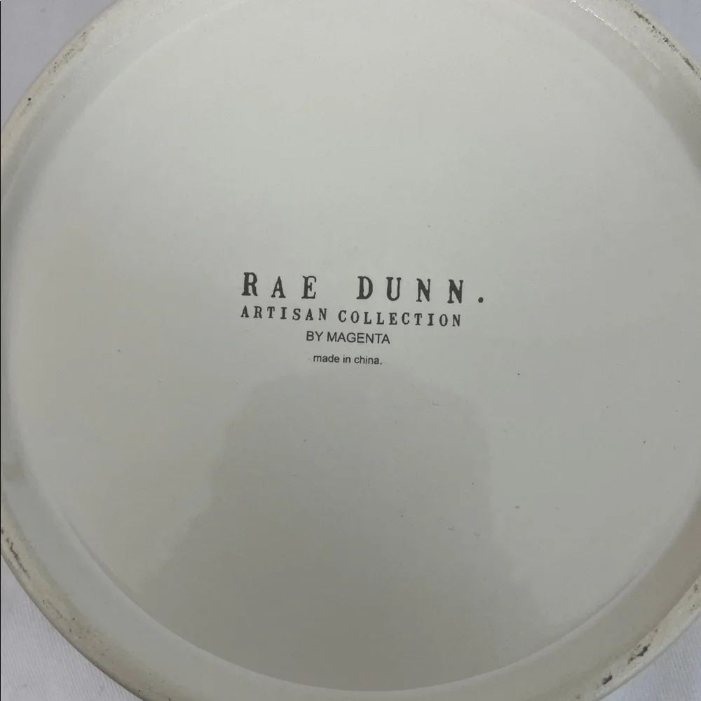 NWOT Rae Dunn white dog bowl 6”wide, 3”tall. Stick on front, WOOF inside bottom
